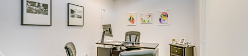 a conference room with a table and chairs and a desk