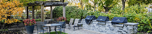 A BBQ Area with tables and chairs at 50 Prince Arthur