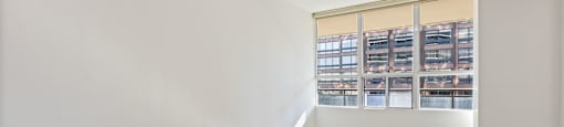 a living room with white walls and a window