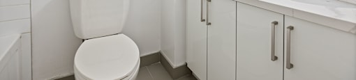 a bathroom with a toilet and a sink and a mirror at A shower with a glass door at 50 Prince Arthur