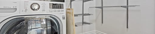 a washer and dryer in a laundry room with shelves