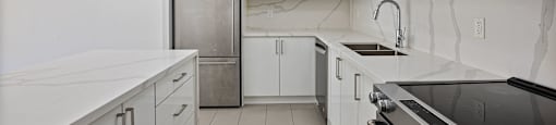 a kitchen with white cabinets and a stainless steel refrigerator at a kitchen with white cabinets and a stainless steel refrigerator at 50 Prince Arthur