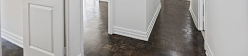 A renovated hallway with white walls in a 2 Bedroom unit at 50 Prince Arthur.