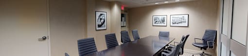a small conference room with a long table and chairs