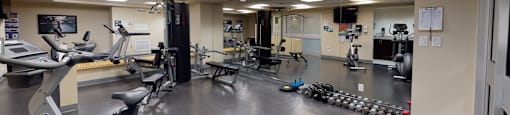 a fitness center with cardio machines and weights