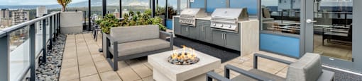 A modern outdoor seating area with a view of the city.