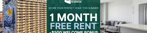 A large building with a sign offering a free month of rent and a $500 welcome bonus.