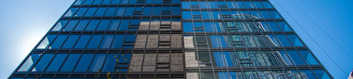 A tall building with a blue sky in the background.