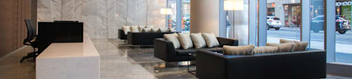 A large room with black furniture and a marble floor.