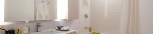 A white bathroom with a toilet, sink, and bathtub.