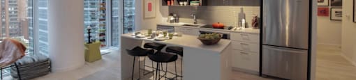 A modern kitchen with a dining table and chairs.