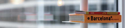 A stack of books with the top one titled Barcelona.
