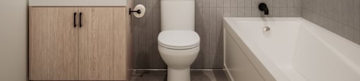 a bathroom with a toilet and a sink and a bath tub