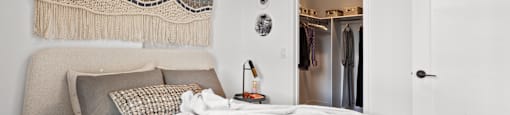 a bedroom with a bed and a door to a closet