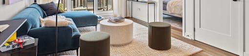 a living room with a couch and a table and a door to a bedroom