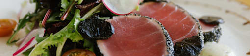 A plate of food with a slice of tuna on top.