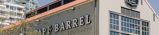 A large building with a sign that says "Ape & Barrel Shipyard".