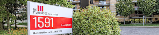 a sign in front of an apartment building in the neighbourhood