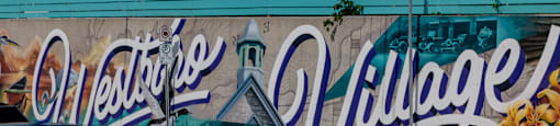 a mural on the side of a building on a city street