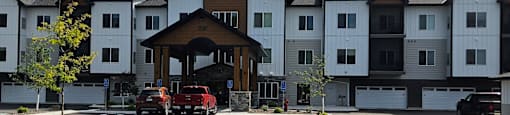 A fire truck is parked in front of a white building.