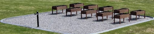 A set of eight chairs are arranged in a circle on a gravel area.