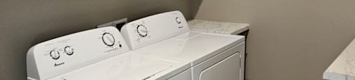 A white washing machine in a laundry room.