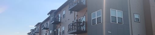 an apartment building with cars parked in front of it