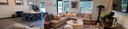 a living room with couches and chairs and a dining room with a piano
