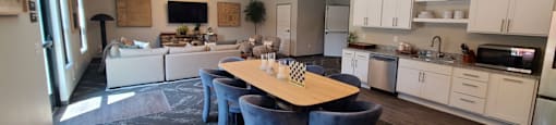 a kitchen and living room with a table and chairs
