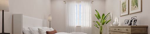 a bedroom with a bed and a dresser and a window