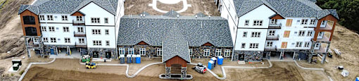 A large building complex with a playground in the middle.