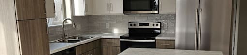 A kitchen with a white island in the middle of it.