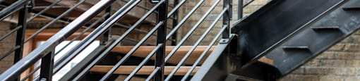 A metal staircase with wooden steps.