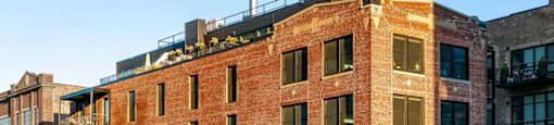 A red brick building with a stop sign in front of it.
