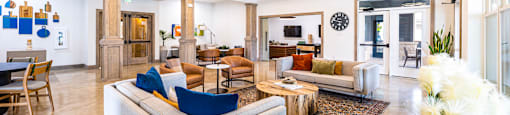 a living room with couches and chairs and a rug at The Parker Austin, Pflugerville