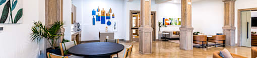 a large living room with a round table and chairs at The Parker Austin, Pflugerville, Texas