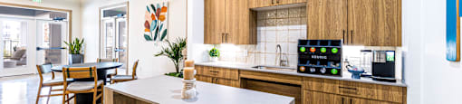 Kitchen with wooden cabinets and a white counter top at The Parker Austin, Pflugerville