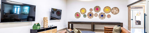 Living room with couches and a tv at The Parker Austin, Pflugerville, TX