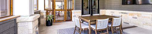 Dining area with a table and chairs and a tv at The Parker Austin, Pflugerville, 78660