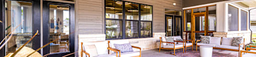 Covered patio with furniture and a ceiling fan at The Parker Austin, Pflugerville, Texas