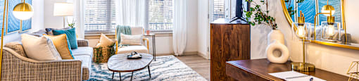 Living room with a couch and a coffee table and a mirror at The Parker Austin, Pflugerville, TX, 78660