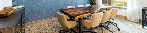 a conference room with a large table and chairs and a blue wall at The Parker Austin, Pflugerville, Texas