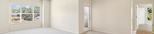an empty living room with a window and a door
