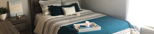a bedroom with a bed and pictures on the wall