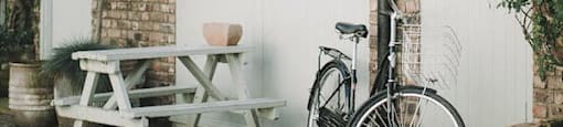 A bicycle is parked next to a white door.