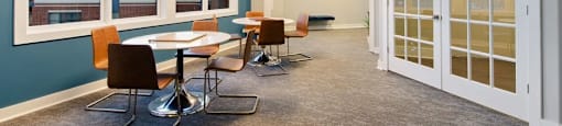 A conference room with a long table and chairs.