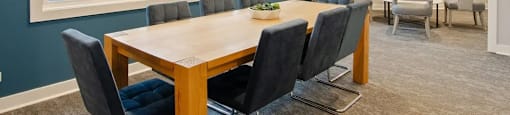 A conference room with a long table and chairs.