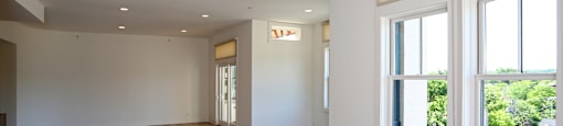 A room with wooden floors and white walls.