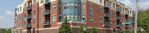 A large apartment building with a mix of brick and glass exterior.