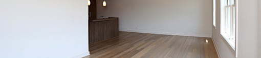 A room with wooden floors and white walls.